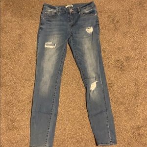 Ripped mid wash blue jeans with rips
